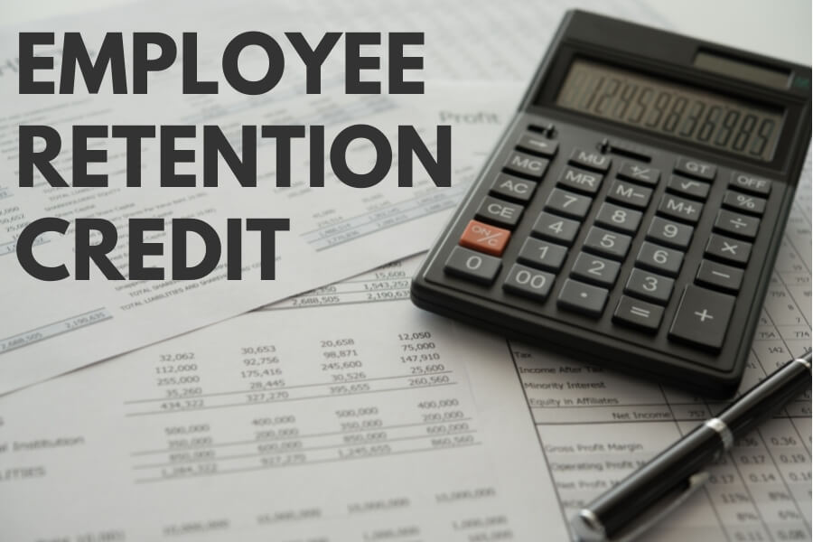 The words Employee Retention Credit written on picture of calculator and paper